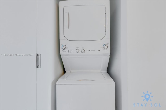 washroom with stacked washer / drying machine