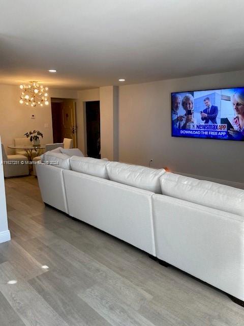 living room featuring a notable chandelier and hardwood / wood-style floors