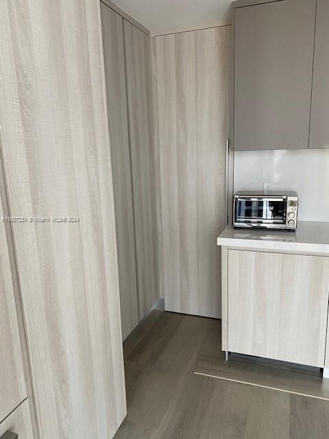 kitchen with light brown cabinets and wood-type flooring