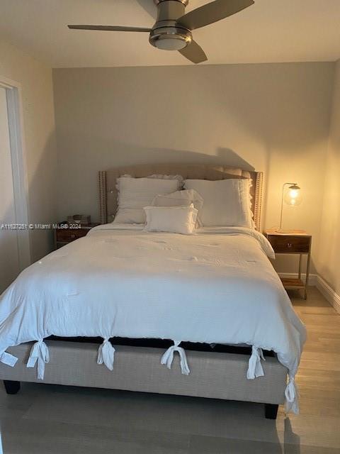 bedroom with wood-type flooring and ceiling fan