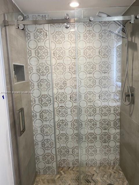 bathroom featuring a shower with shower door