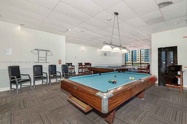 rec room with dark carpet, a paneled ceiling, and pool table