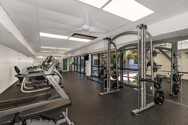 exercise room featuring a drop ceiling and ceiling fan