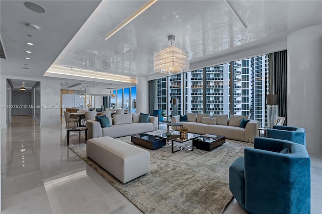 living room with a wall of windows, tile patterned floors, a raised ceiling, and a chandelier