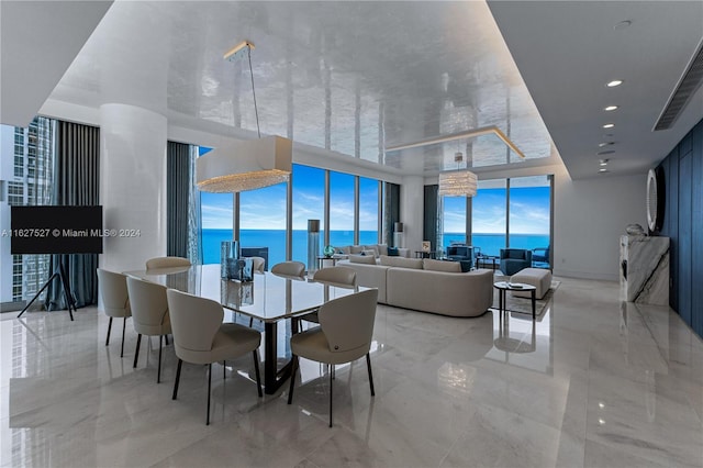 tiled dining room featuring a water view