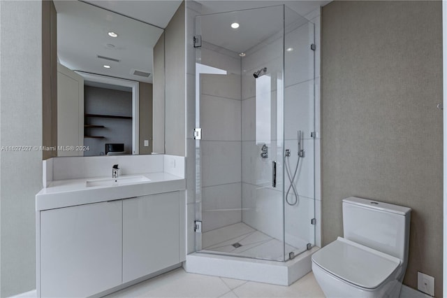 bathroom with tile patterned floors, toilet, vanity, and an enclosed shower