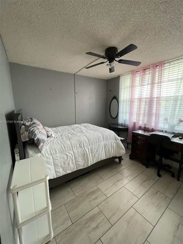 bedroom featuring a textured ceiling and ceiling fan