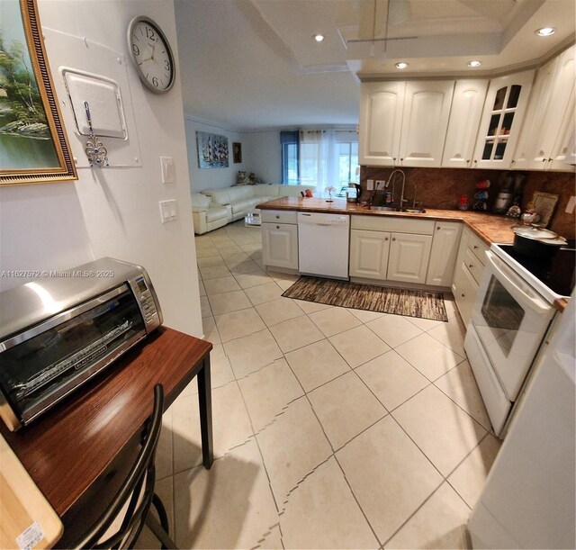 1425 Atlantic Shores Blvd Unit 409, Hallandale Beach, FL 33009 - kitchen with white appliances, a sink, white cabinetry, a peninsula, and open floor plan
