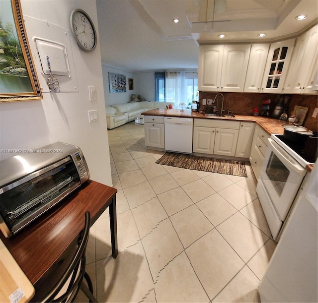 kitchen with white cabinetry, sink, backsplash, light tile patterned floors, and white appliances