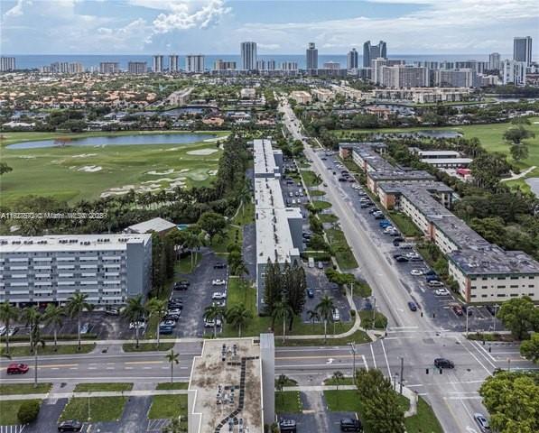 1425 Atlantic Shores Blvd Unit 409, Hallandale Beach, FL 33009 - drone / aerial view featuring a water view, a view of city, and golf course view