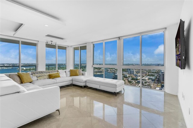 sunroom with a water view and a wealth of natural light