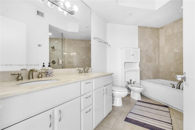 full bathroom with a bidet, vanity, tile patterned floors, independent shower and bath, and toilet