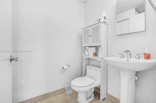 bathroom with tile patterned flooring and toilet