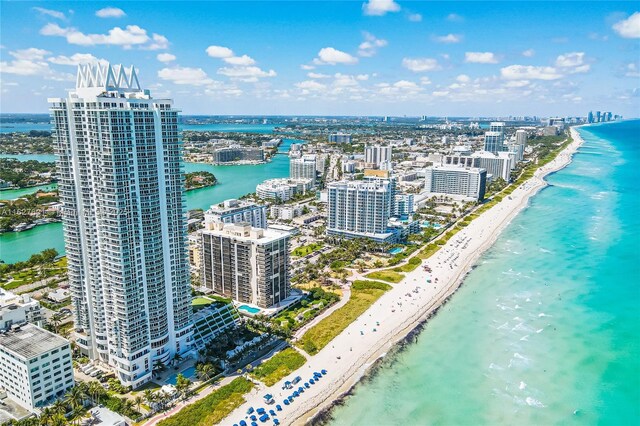 birds eye view of property with a water view and a view of the beach