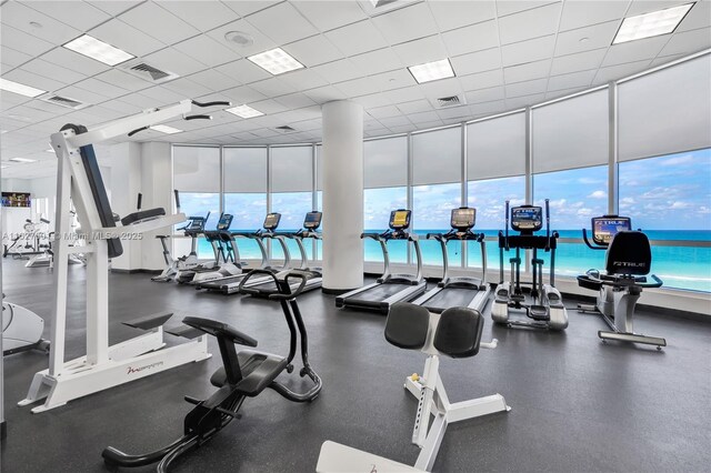 exercise room with a water view