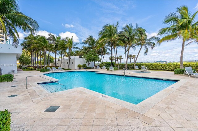 view of swimming pool with a community hot tub and a patio area