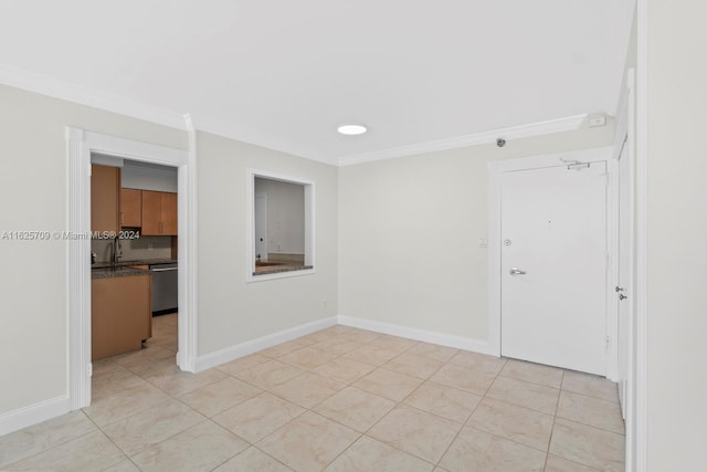 spare room with light tile patterned flooring and crown molding