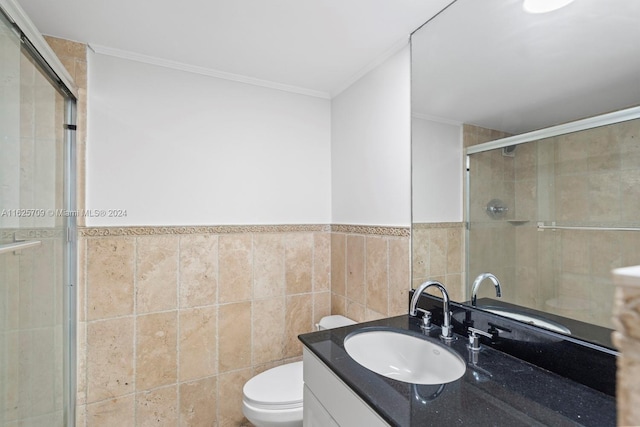 bathroom featuring toilet, vanity, tile walls, and an enclosed shower