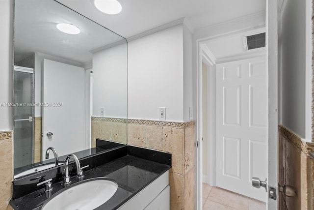 bathroom featuring vanity, tile patterned floors, and ornamental molding