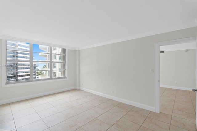 empty room featuring light tile patterned floors and ornamental molding