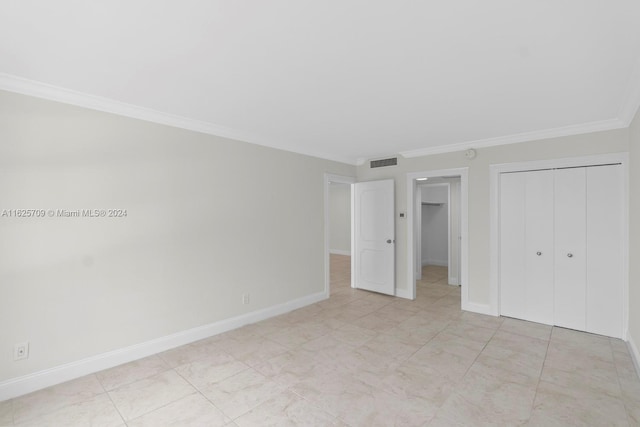 unfurnished bedroom featuring a closet and crown molding