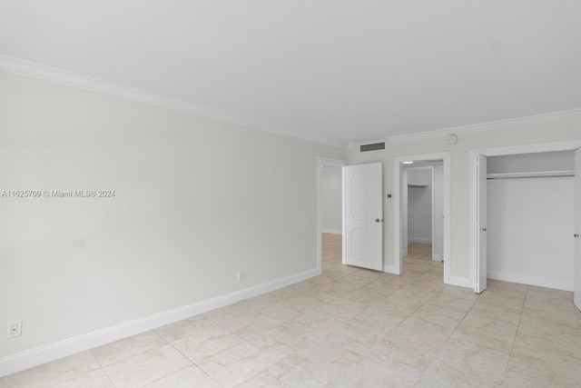 unfurnished bedroom featuring a closet and crown molding