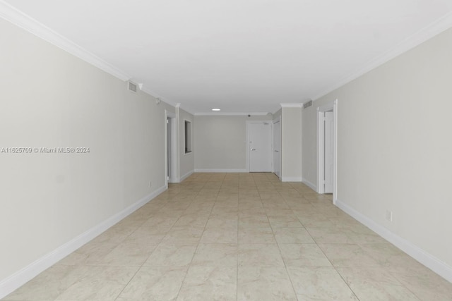 spare room featuring light tile patterned floors and crown molding