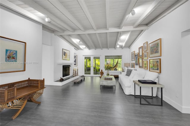 living room featuring french doors and vaulted ceiling with beams