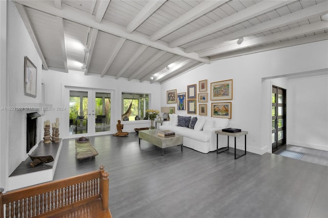 living room featuring vaulted ceiling with beams and french doors