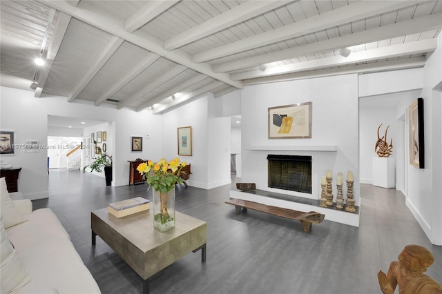 living room featuring vaulted ceiling with beams