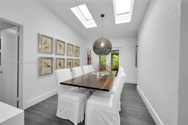 dining room with dark wood-type flooring and vaulted ceiling with skylight