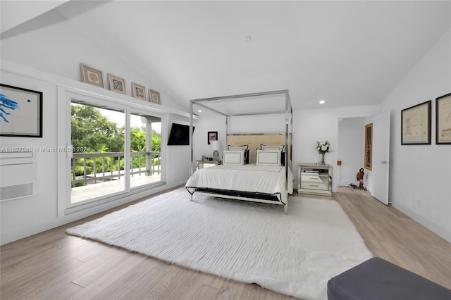 bedroom with light hardwood / wood-style floors, access to outside, and high vaulted ceiling