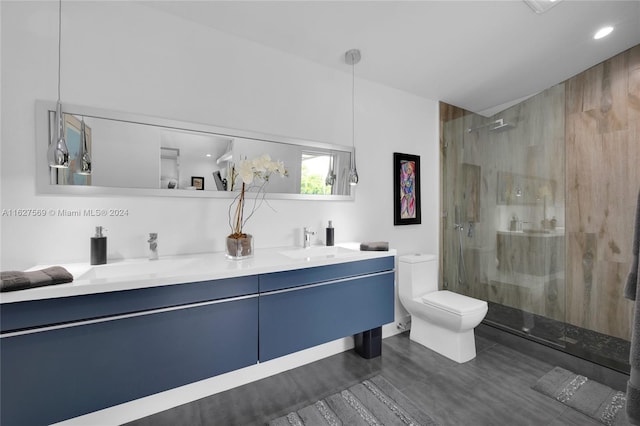 bathroom with walk in shower, toilet, and double sink vanity