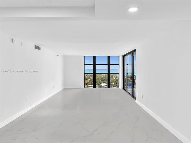 unfurnished room featuring floor to ceiling windows