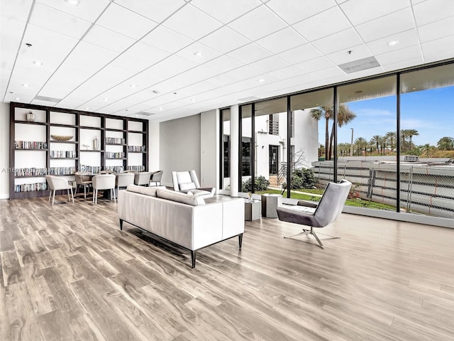 living room featuring floor to ceiling windows and light wood-type flooring