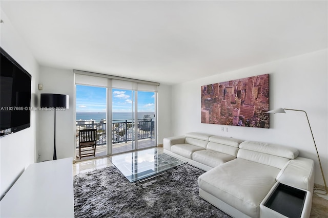 living room featuring expansive windows and a water view