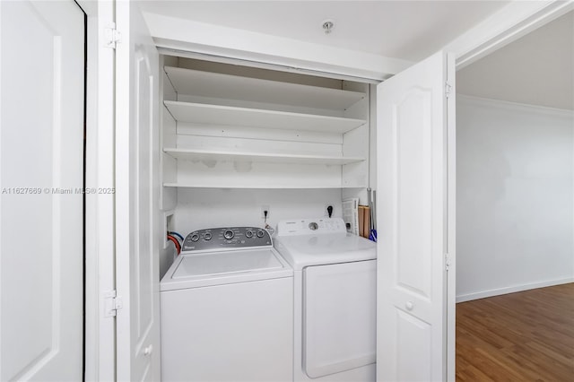 laundry area featuring separate washer and dryer and dark wood-type flooring