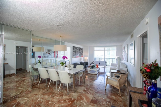 dining room with a textured ceiling