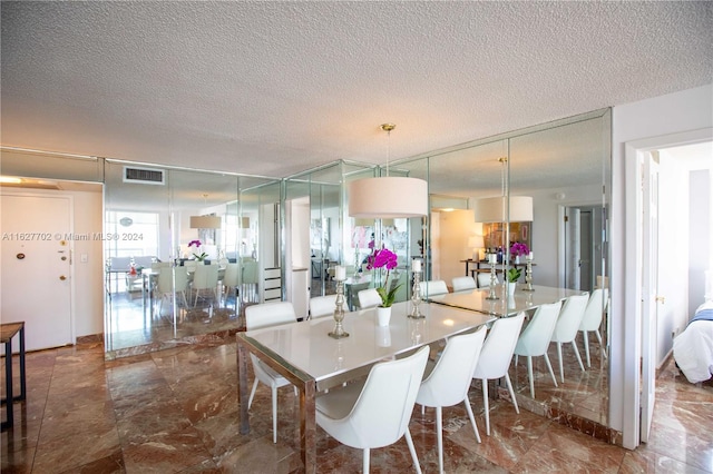 dining area featuring a textured ceiling