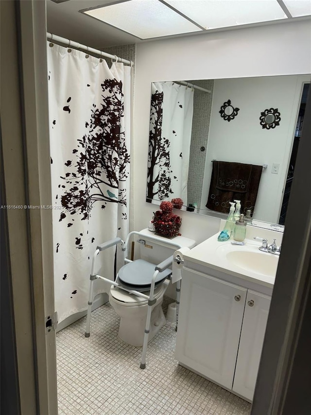 bathroom featuring vanity, tile patterned flooring, toilet, and a shower with shower curtain