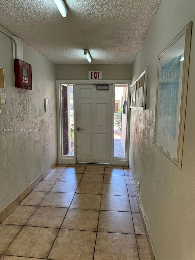 tiled foyer entrance featuring a textured ceiling