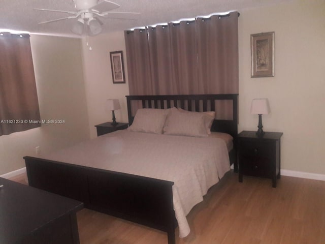 bedroom featuring ceiling fan and hardwood / wood-style flooring