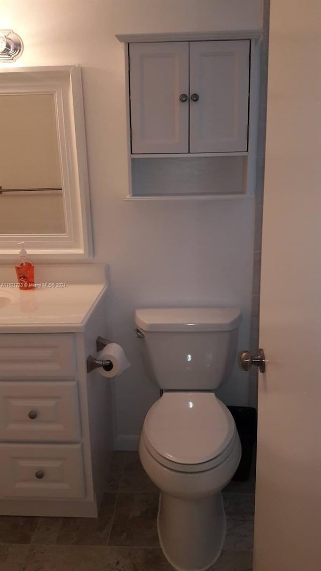 bathroom featuring vanity, toilet, and tile patterned floors