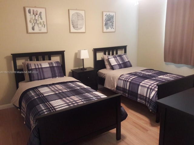 121 SE 3rd Ave Unit 201, Dania Beach, FL 33004 - bedroom featuring baseboards and wood finished floors