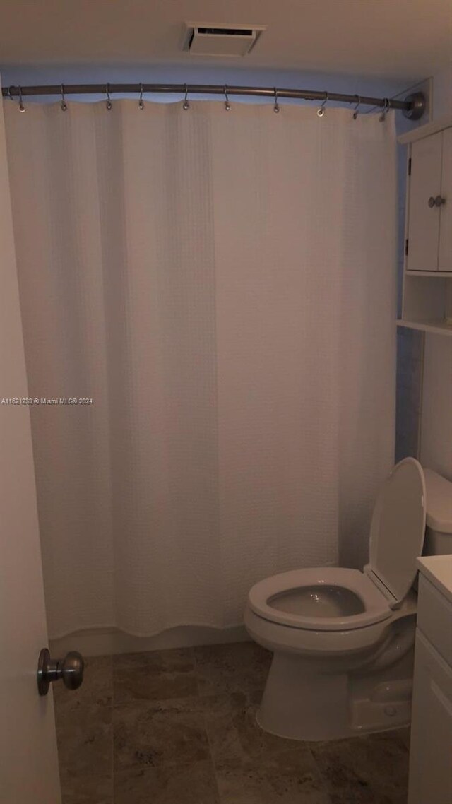 bathroom with vanity, toilet, and tile patterned floors