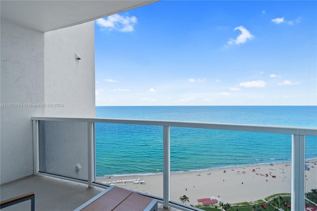 balcony featuring a water view and a view of the beach