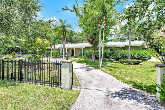 ranch-style home featuring a front yard