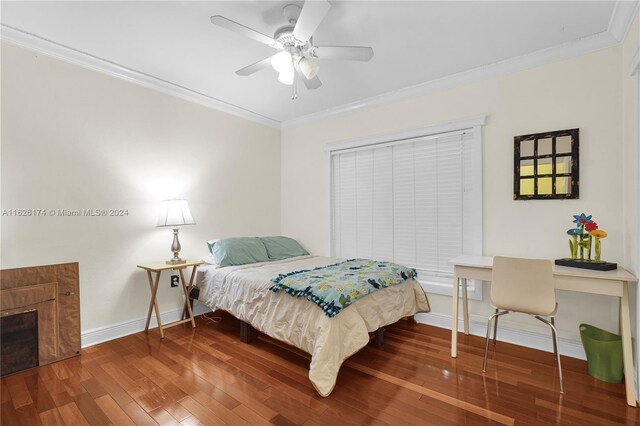 bedroom with ceiling fan, ornamental molding, and hardwood / wood-style flooring