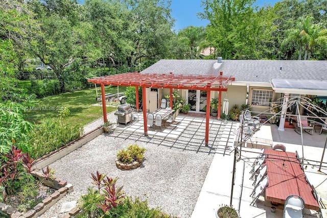 rear view of house with a pergola, a lawn, and a patio