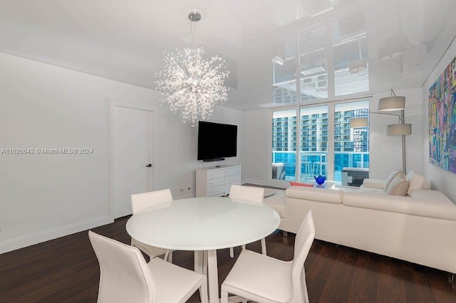 dining area featuring dark hardwood / wood-style flooring and a notable chandelier